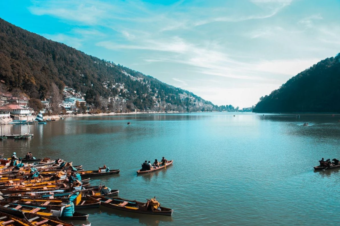 Wide view of Naini Lake with boats and surrounding hills
